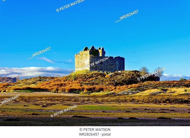 Castle Tioram on the coastal island Eilean Tioram where River Shiel and Loch Moidart meet, at low tide on a sunny winter morning, Highlands, Scotland