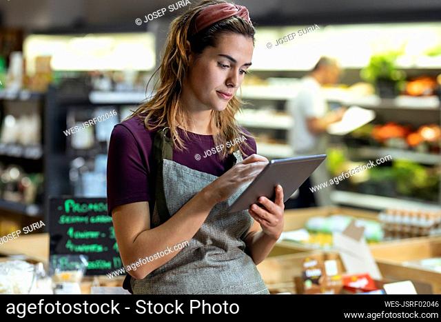 Store owner using tablet PC in organic market