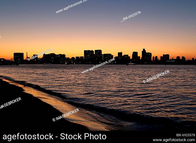 View from Odaiba Beach to Tokyo Bay with skyline silhouette at dusk, Tokyo, Japan, Asia