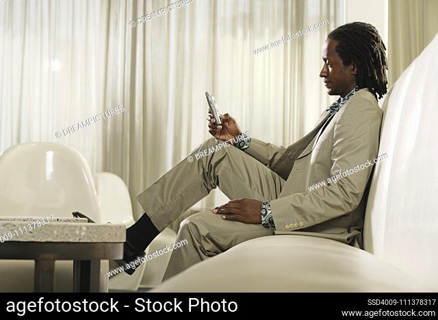 African man dialing cell phone