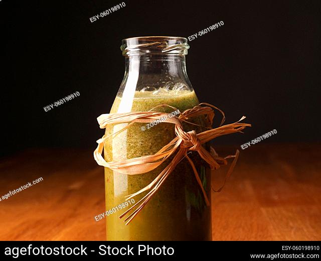 Healthy vegetable fruit smoothie from organic ingredients on a wooden kitchen table