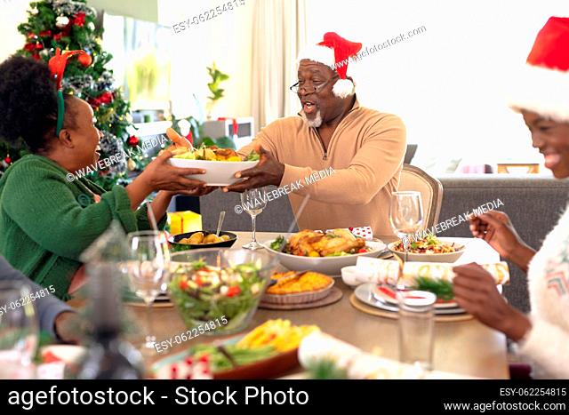 Happy african american family spending time together having christmas meal