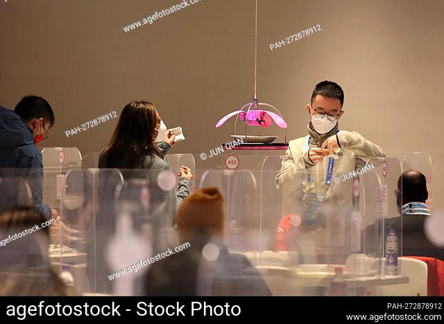 Side motif: Restaurant in the Olympic bubble - dining room, dishes, plates are transported to the tables by robots and accepted there