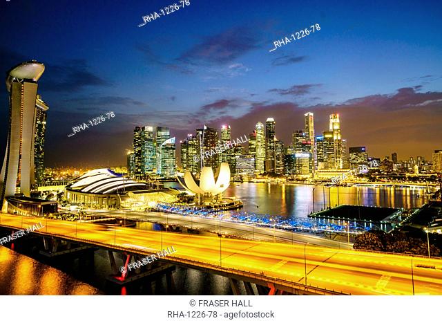 Busy roads leading to the Marina Bay Sands, Gardens by the Bay and ArtScience Museum at dusk with the skyline beyond, Singapore, Southeast Asia, Asia
