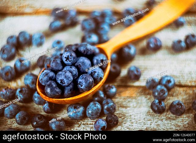 Blueberry with top view of wooden spoon on wooden table