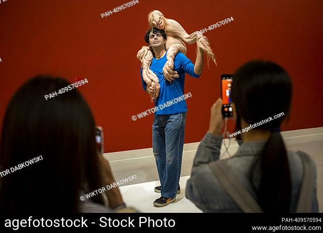 People look at The Sapling a sculpture by Patricia Piccinini during the SUPERNATURAL: Sculptural Visions of the Body exhibition in Taipei