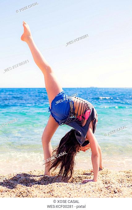 Girl doing gymnastics on the beach, Stock Photo, Picture And Royalty Free  Image. Pic. WES-XCF00281 | agefotostock