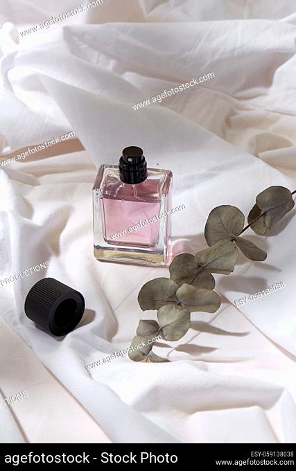 bottle of perfume and on white sheet
