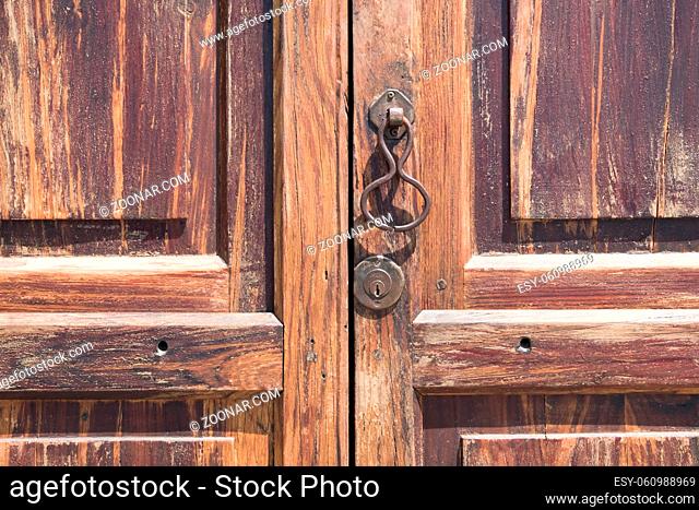 metal knocking knob on wooden door closeup