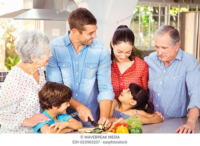 Happy family preparing food in kitchen