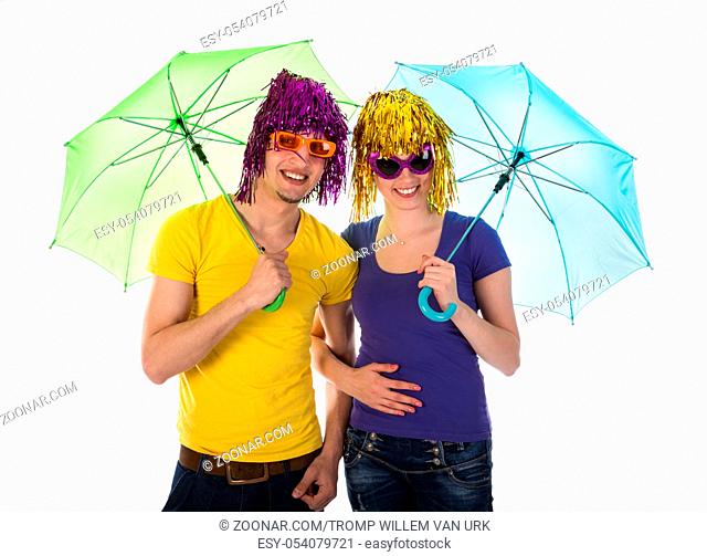 Couple with wigs, sunglasses and umbrellas