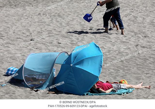Beach visitors enjoy the sunny weather at the Baltic resort KÃ¼hlungsborn, Germany, 26 May 2017. On the last weekend of the month the high ""Walrita"" is...