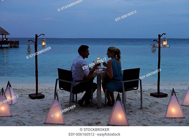 Couple Enjoying Late Meal In Outdoor Restaurant