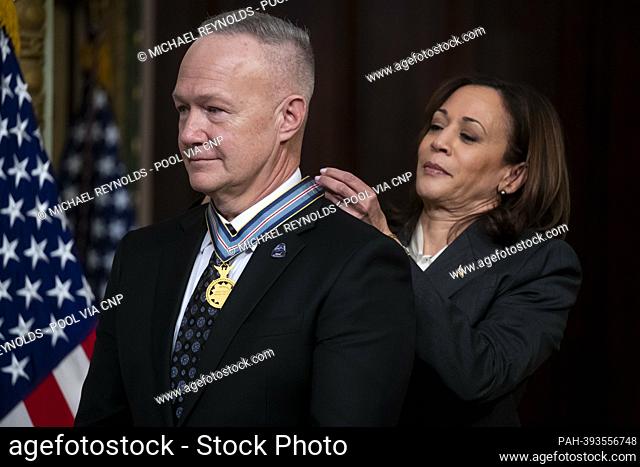 United States Vice President Kamala Harris (R) awards the Congressional Space Medal of Honor to former NASA astronaut Douglas Hurley (L)
