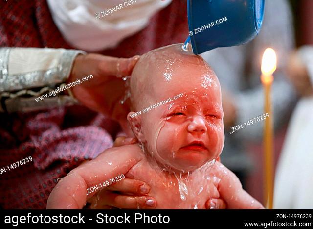 Belarus, the city of Gomel, the St. Nicholas Monastery, 10.09.2016.The rite of Orthodox baptism. The child is watered with water