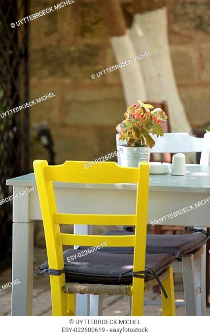 Close-up from a Yellow chair and white table