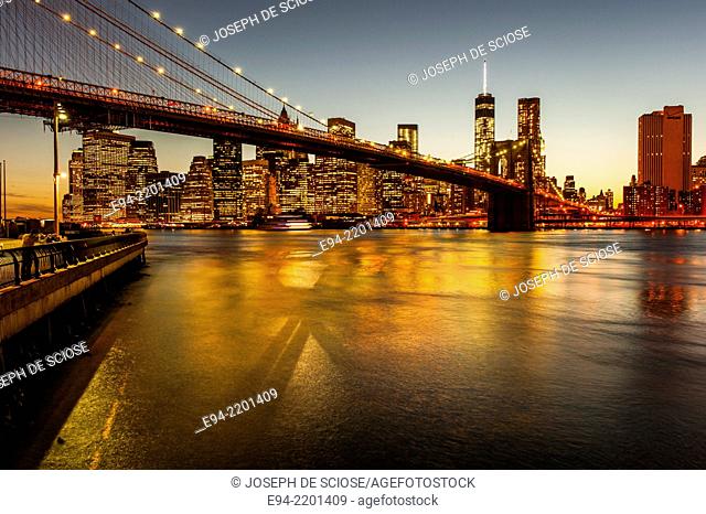 The Brooklyn Bridge, the East River and the Finanancial District with the new World Trade Center building , New York City at Sunset