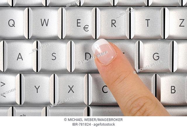 Apple MacBook Pro keyboard, laptop, finger pointing at the Euro symbol
