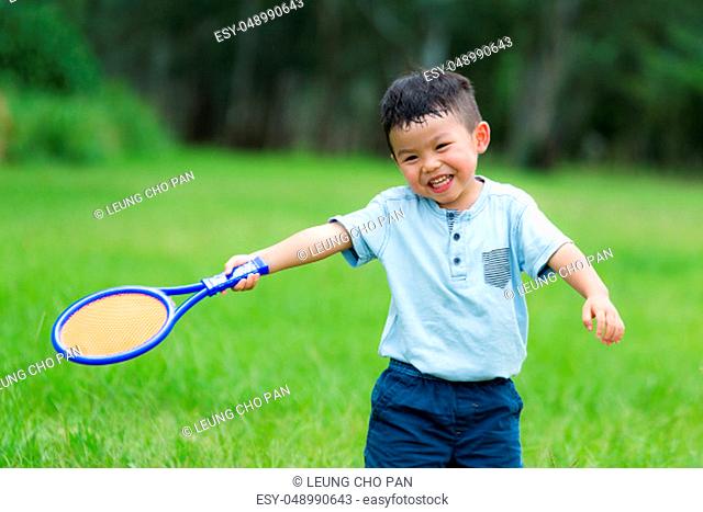 Thrilled Little kid play with tennis