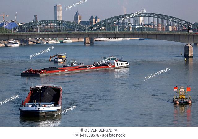 A dredger digs gravel out of the the Rhine in Cologne, Germany, 20 August 2013. A combined push boat and barge lie in front of the dredger