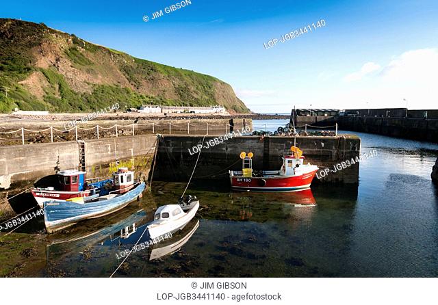 Scotland, Scottish Borders, Burnmouth. Boats in the small fishing harbour at Burnmouth, the first village in Scotland on the A1 after crossing the border with...