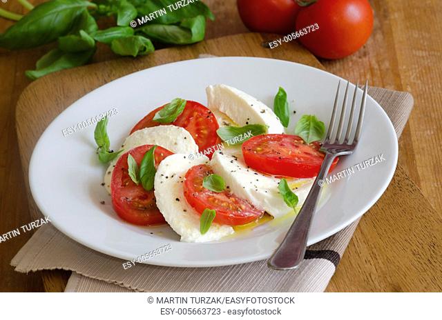 Delicious Caprese salad made of Mozzarella, tomatoes and basil