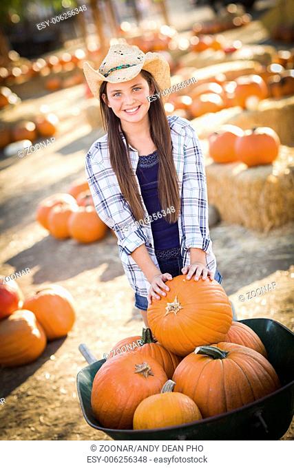 Preteen Girl Playing with a Wheelbarrow at the Pumpkin Patch