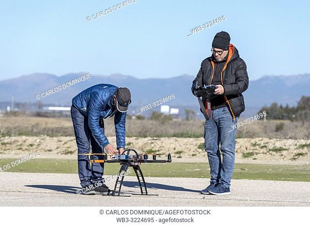 Professional drone being prepared by pilot assistant