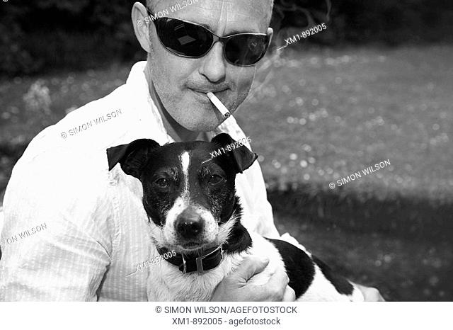 Portrait of young man with Jack Russell pet dog