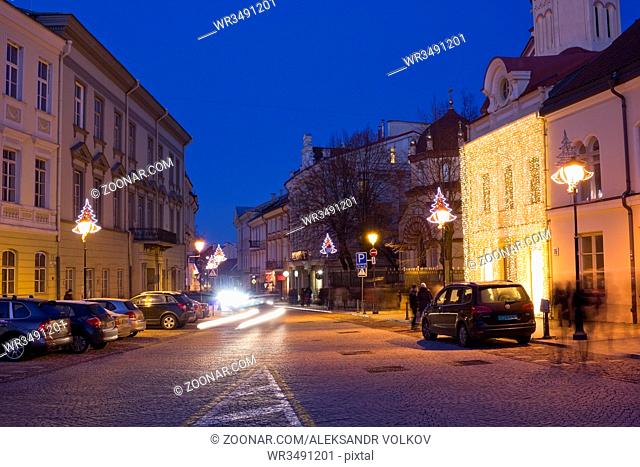 VILNIUS, LITHUANIA - DECEMBER 26, 2014: Christmas street and light illumination in the old european town. Frozen December Xmas night urban landscape