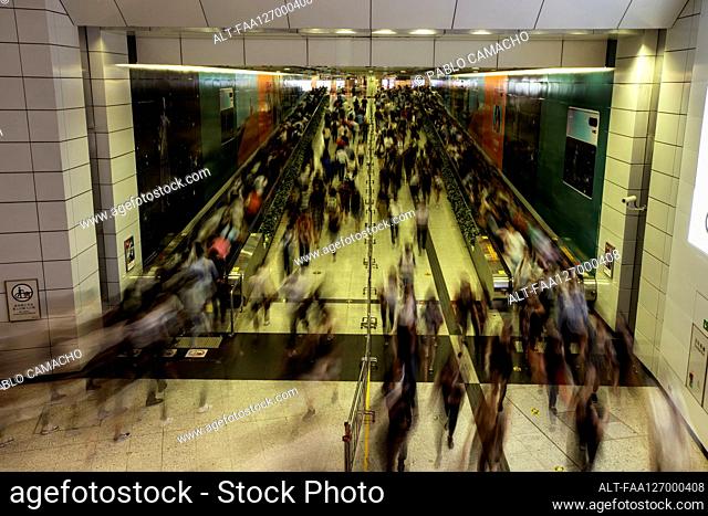 Busy commuters in subway station during rush hour in Hong Kong