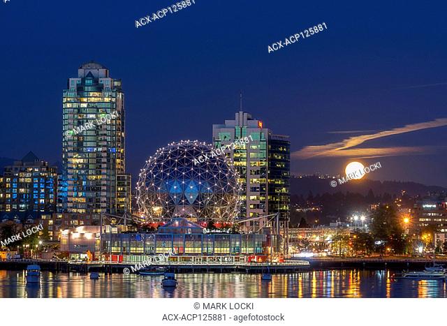 The Harvest Moon rises next to Science World, False Creek, Vancouver, British Columbia, Canada