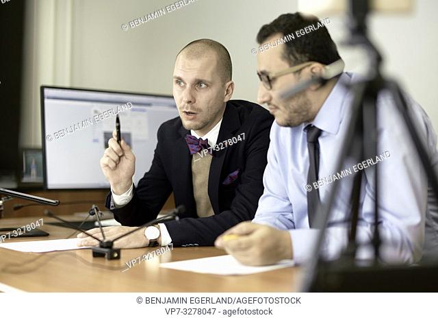 concentrated business men debating arguments at conference, in office, in Cottbus, Brandenburg, Germany
