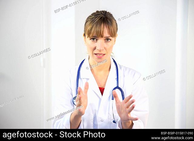 A female doctor in her white coat talking to a patient