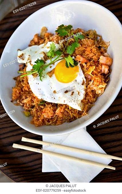 Fried egg, rice and grilled shrimp on a plate