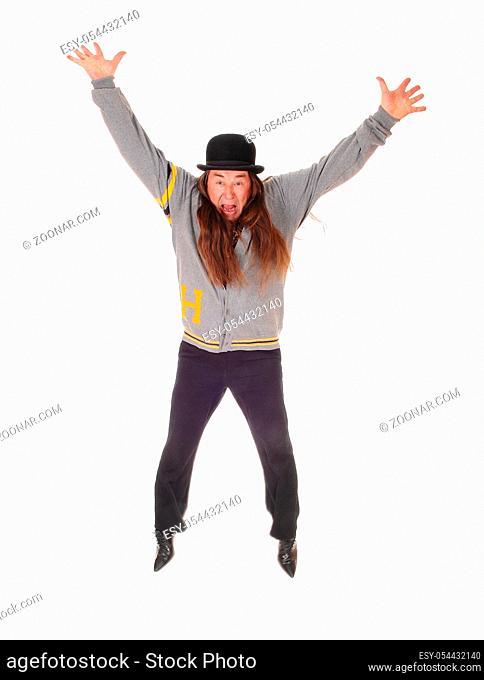 An indigenous man in a gray jacket and black pants jumping for happiness in the air, isolated for white background