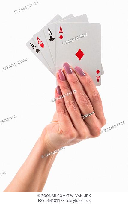 Female hand showing four aces cards isolated over white background