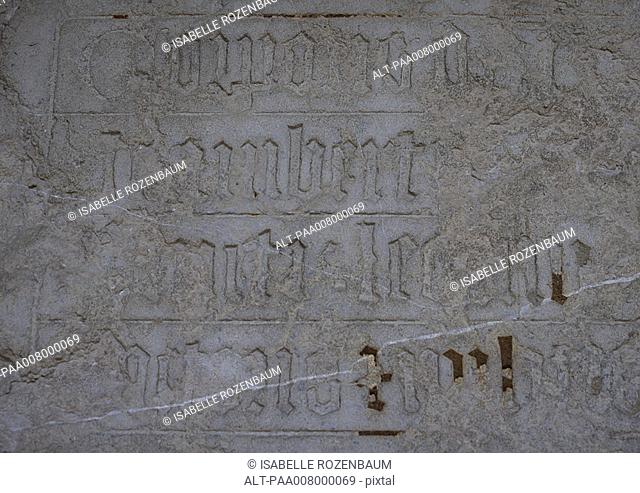 Gothic writing engraved in stone