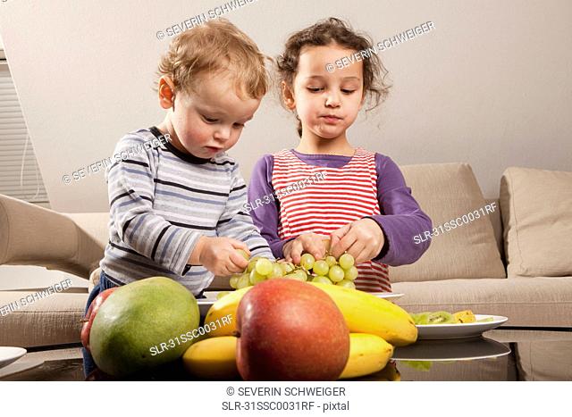 Boy and girl eating fruit