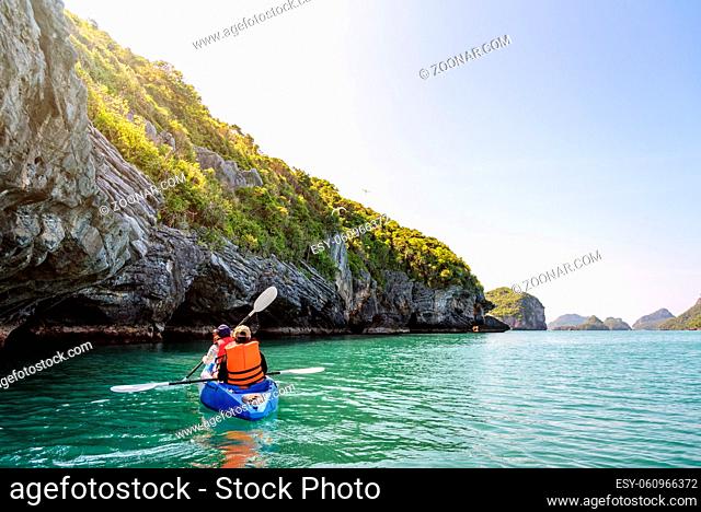Two women are mother and daughter. Travel by boat with a kayak on the sea under sunlight at summer around Ko Phi enjoy the beautiful nature of the sea and...