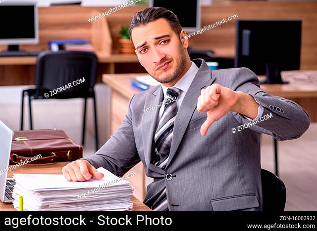 Young male employee working in the office environment