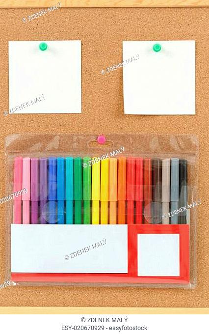 color markers with notes on cork board