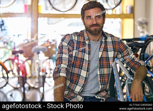 Owner sitting in bicycle shop
