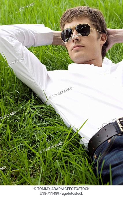 a man laying down on the grass