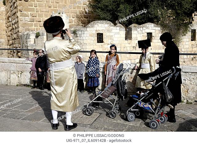Orthodox Jew taking a family picture in the old city of Jerusalem, Israel