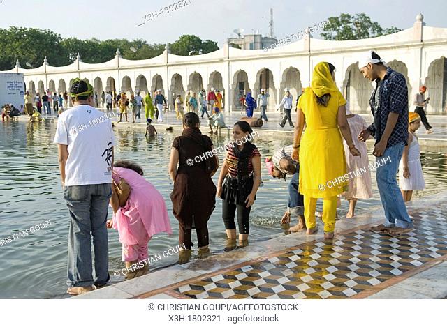 followers by the ' Sarovar' pond whose water is considered holy, inside Gurudwara Bangla Sahib, the most prominent Sikh gurdwara, or Sikh house of worship