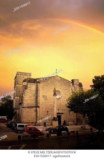 After a rainstorm a rainbow appears over the 13th century Church of St. Saturnin on the outskirts of Pezenas, France