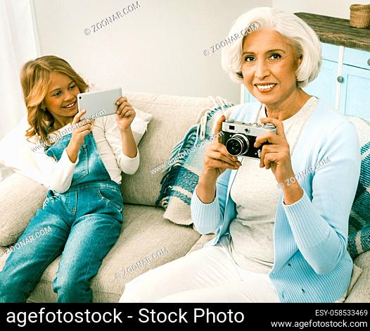 Granddaughter Taking Photos Or Videos On Her Seasonal Gift For White Haired Italian Grandmother Upgrading Her With New Smartphone
