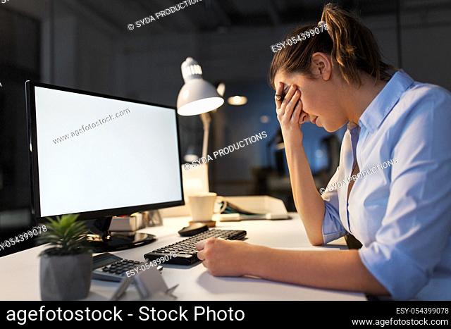 sad businesswoman with computer at night office