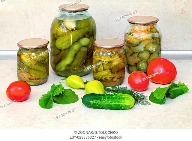 Canned cucumbers with spices in glass jars